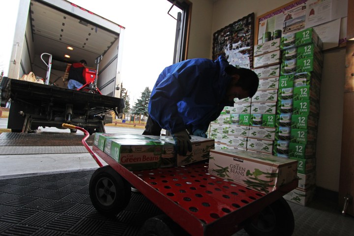 A Food Bank of Alaska worker picks up a donation of canned goods at Leake Temple AME Zion Church.